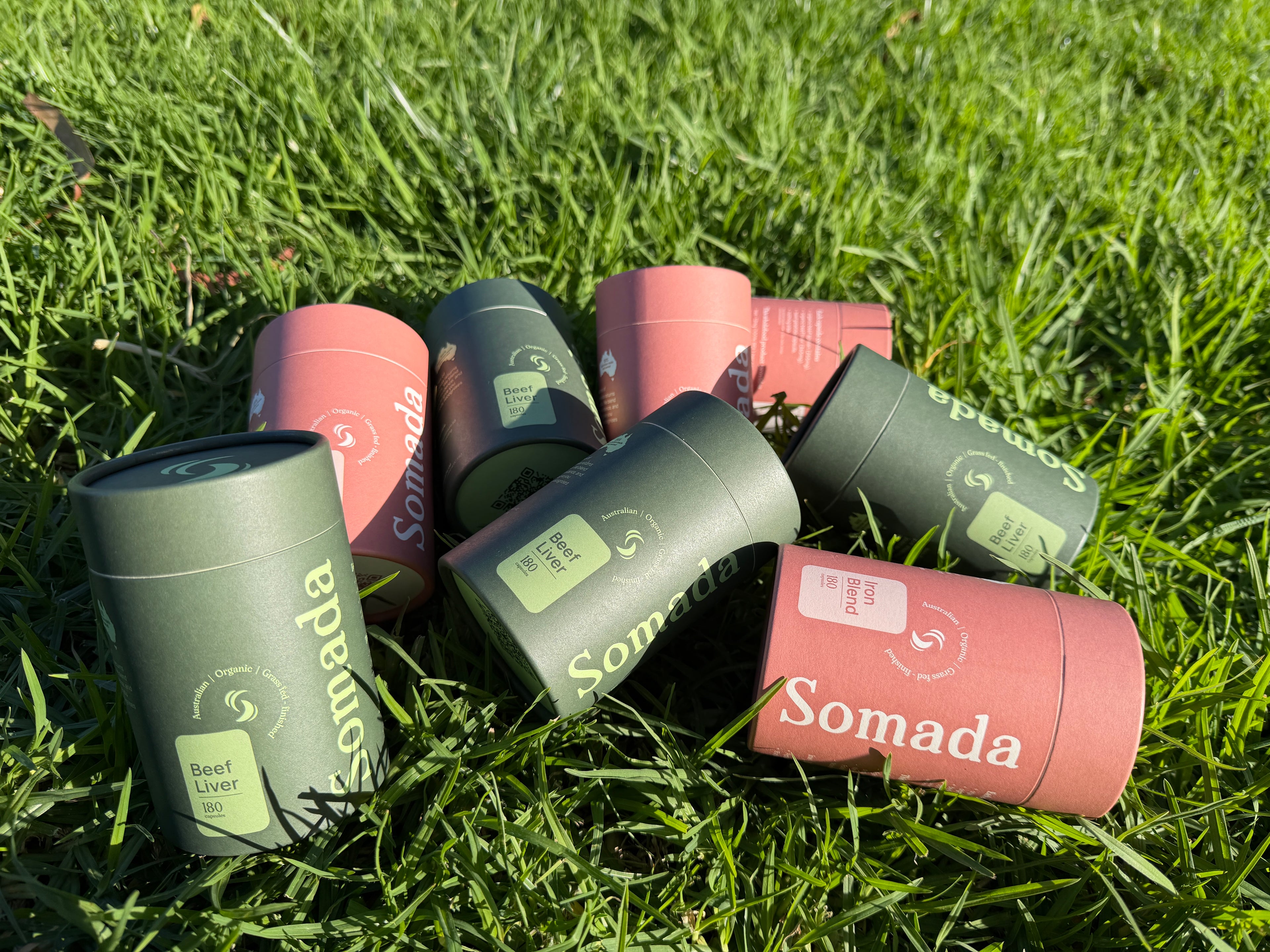 Somada products in green and pink on grass